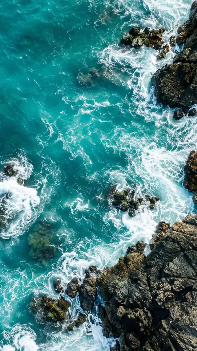 Waves crashing on coastal rocks seen from above, made with Veo 3.1 Lite